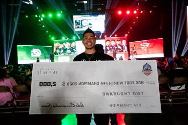Ivan Ortega-Nguyen holds a check at the Halo Championship Series as he was the HCS Fort Worth Major FFA Champion